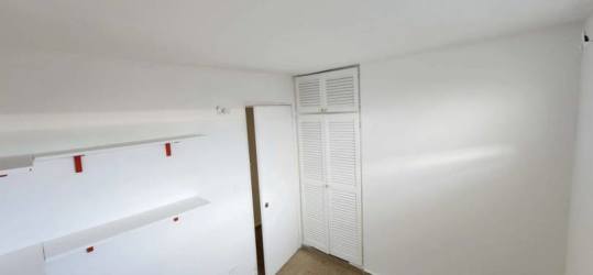 L-shape kitchen with granite counters, wood cabinetry at Santa Clara Panama home