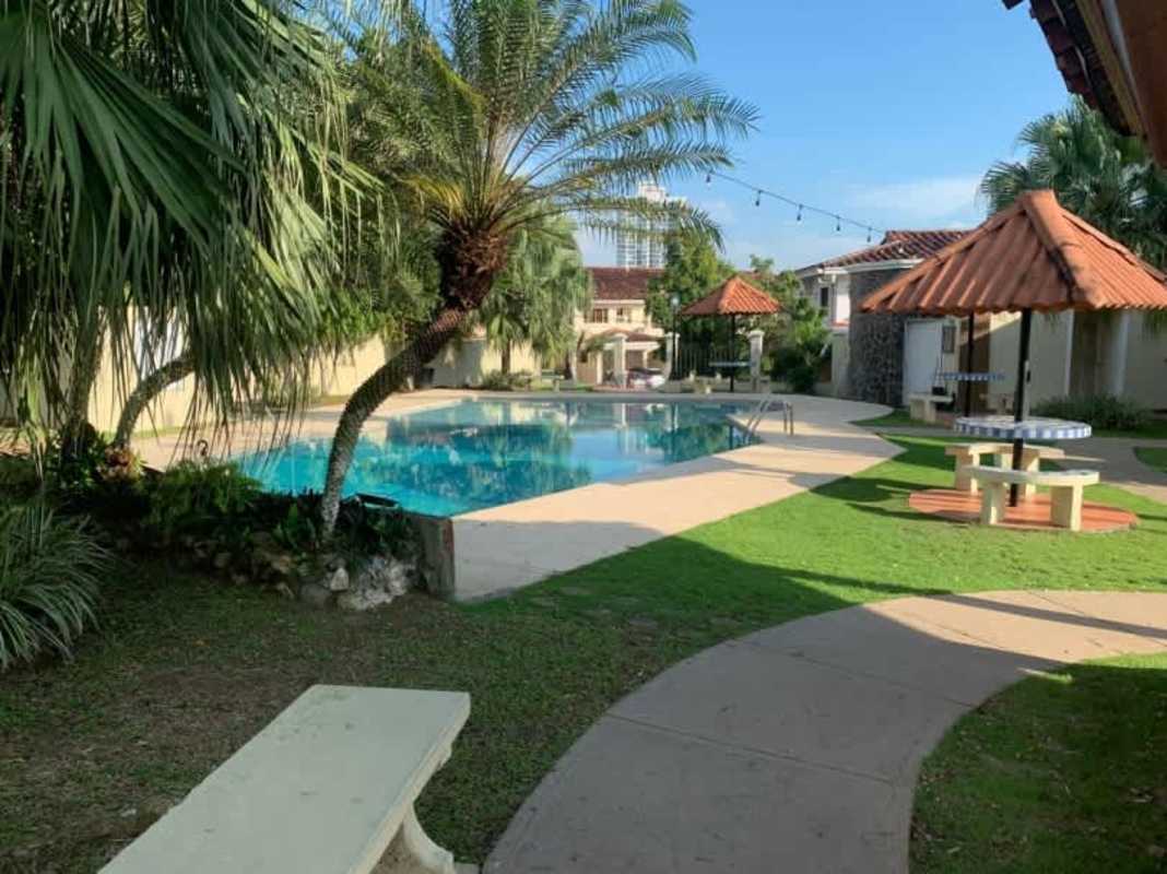 Living room featuring arched doorway, sofa set, ceiling fan, and large windows Betania Panama