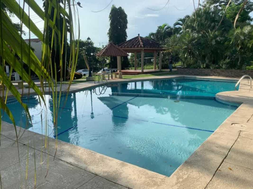 Large windows leading to balcony with city views Betania two story house