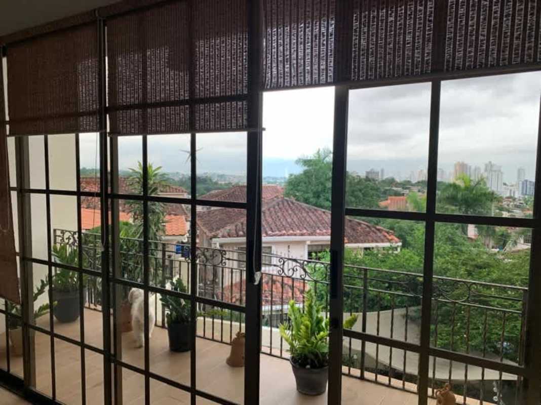 Interior staircase with decorative iron railing in two-story Betania home for sale