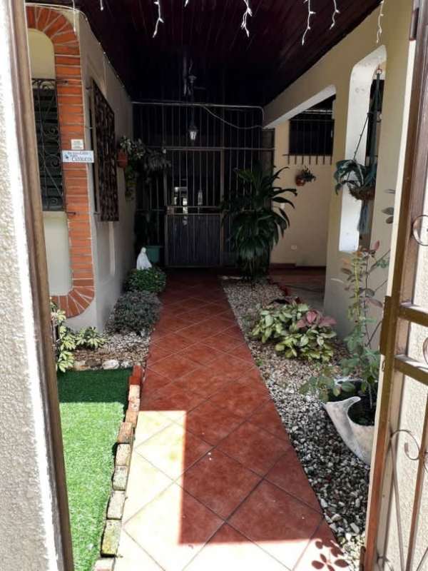 Bright living area with accent walls, recliner sofas, artwork and ceramic floors in Villa de Las Fuentes Panama