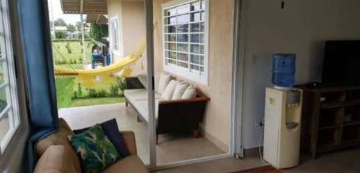 Living room with sliding glass door to patio with hammock at PH Coronado Playa Panama
