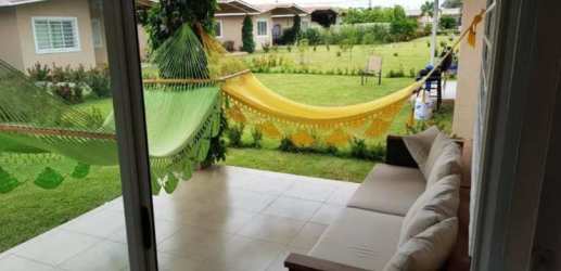 Outdoor garden patio with lawn, seating, and hammocks in PH Coronado Panama