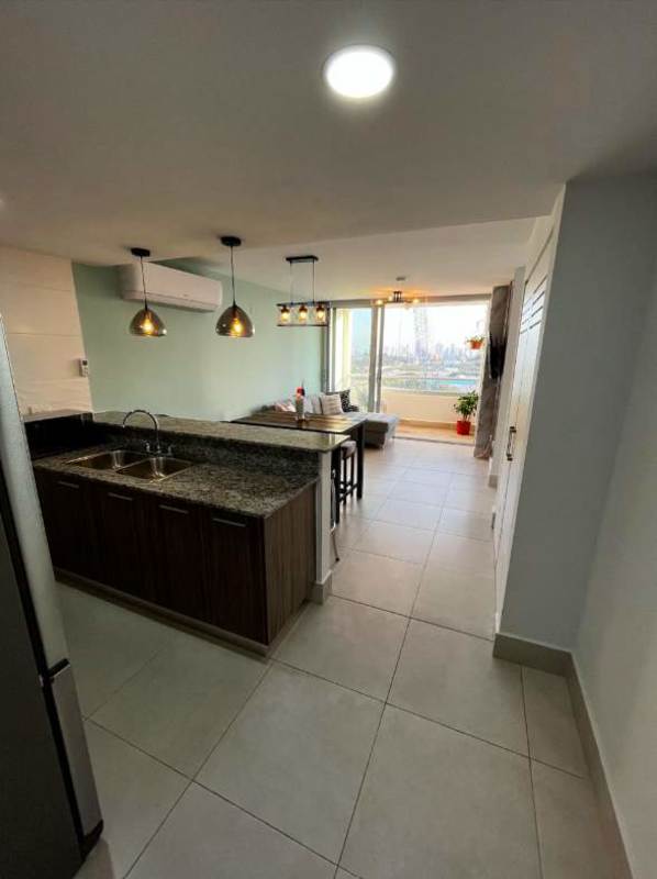 Modern kitchen in Condado del Rey apartment featuring granite countertops, breakfast bar, appliances