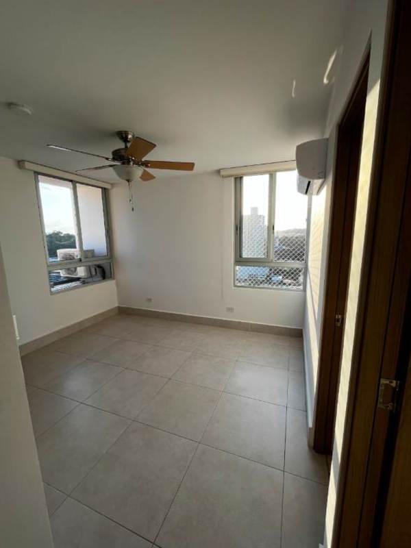 Bedroom with safety mesh large windows, ceiling fan, tiled floor, city view, in Condado del Rey Panama