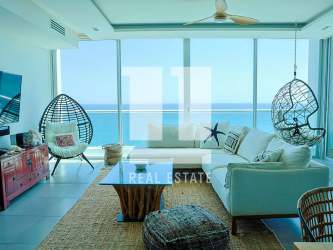 Bright living room with floor-to-ceiling windows ocean view in Rio Mar Torre Continental Panama
