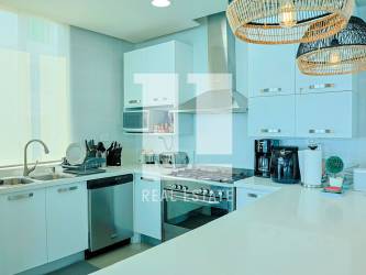 Modern kitchen island granite countertop stainless appliances Rio Mar Torre Continental condo Panama