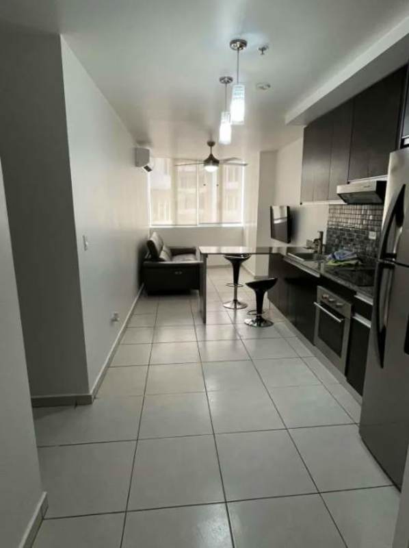 Bright living and kitchen area with breakfast bar, mosaic backsplash, modern appliances PH Luxor Towers Obarrio Panama