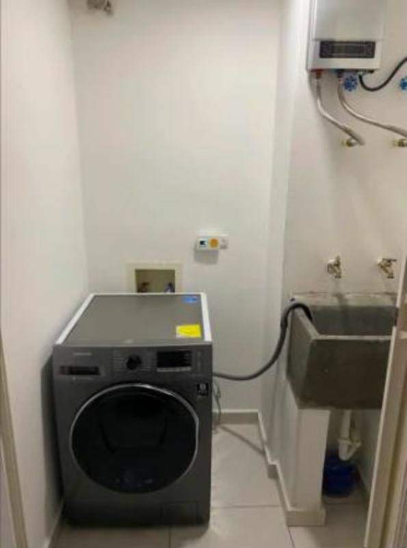 Laundry space with washing machine hookup, utility sink, and water heater in PH Luxor Towers Obarrio Panama