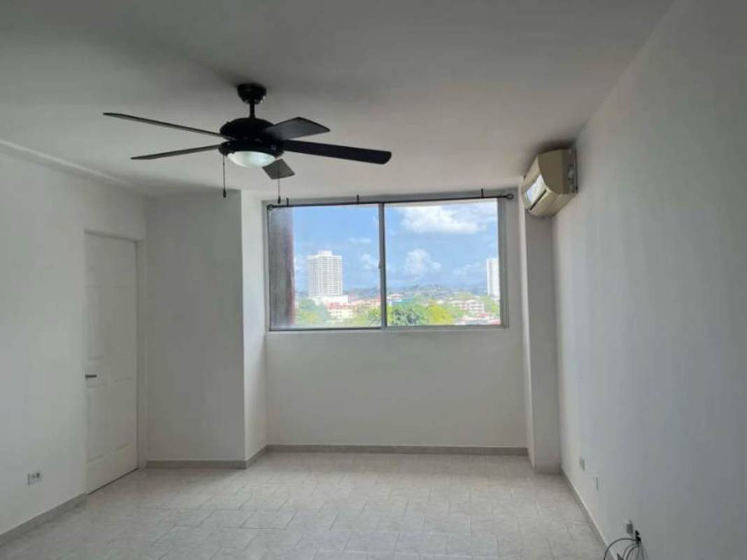 Modern apartment bedroom with city view window and tile flooring PH Parque Lefevre Panama