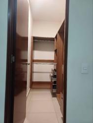 Spacious walk-in closet with shelves and hanging rods in River Valley Panama Pacifico