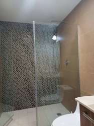 Modern bathroom featuring glass shower with mosaic tile and vanity River Valley Panama Pacifico