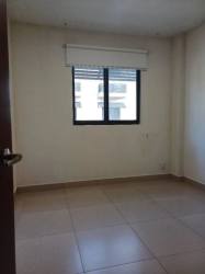 Simple empty bedroom with tile floor and large window Panama Pacifico