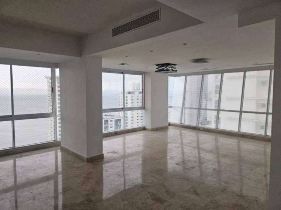Spacious living room with marble floors, balcony and panoramic ocean views at PH Ocean House Costa del Este Panama