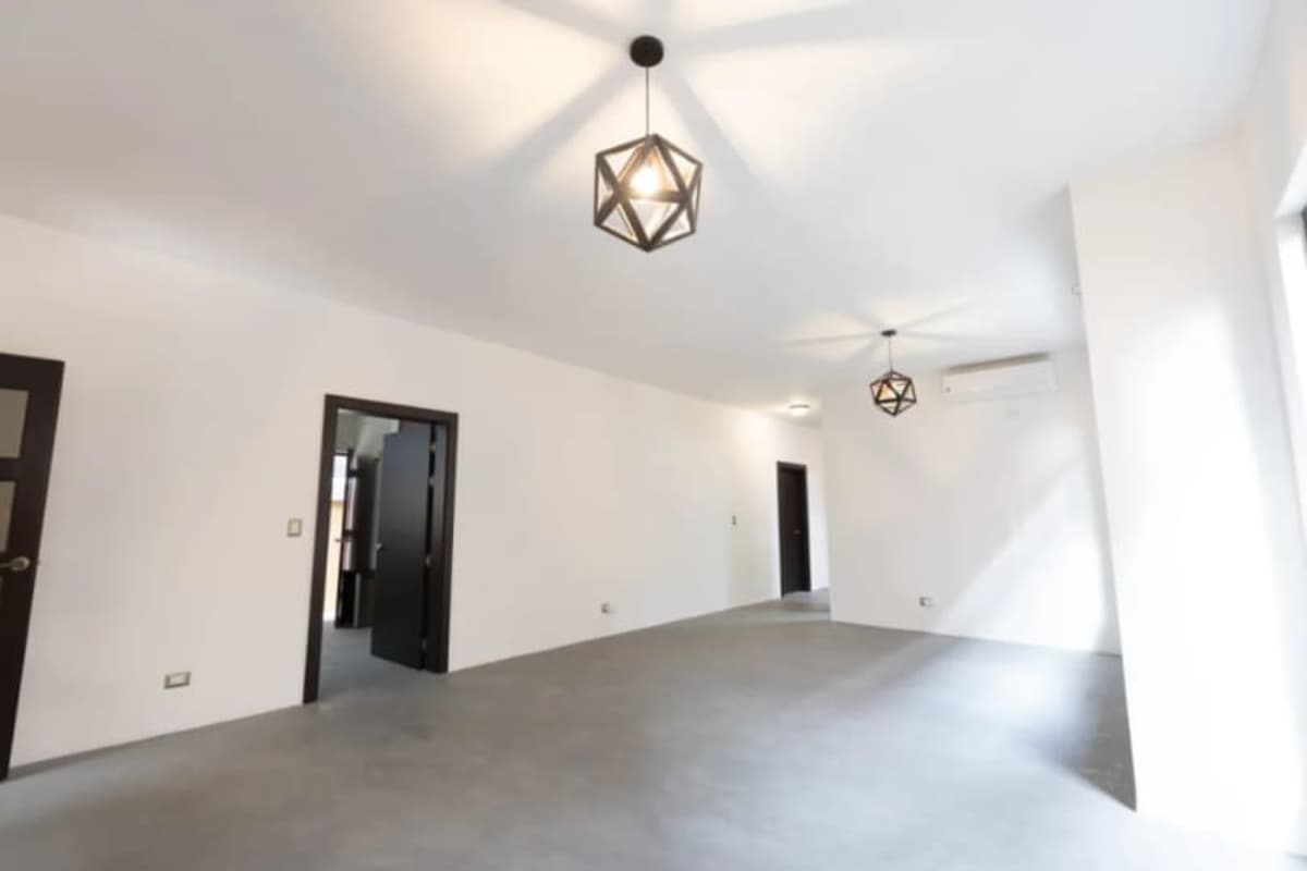 Spacious living room with polished floors, AC, modern lighting in Costa Sur residence Panama