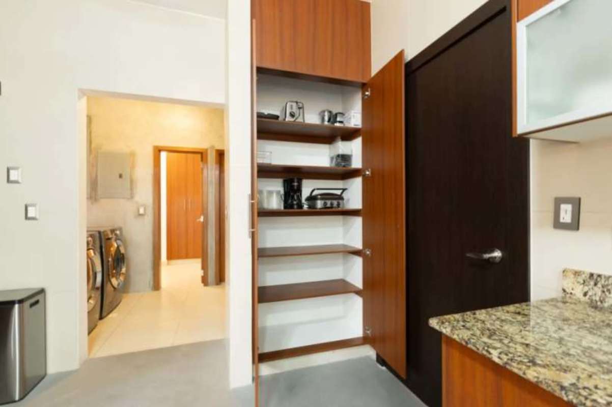 Laundry room with washer dryer, concrete walls in Costa Sur Panama house