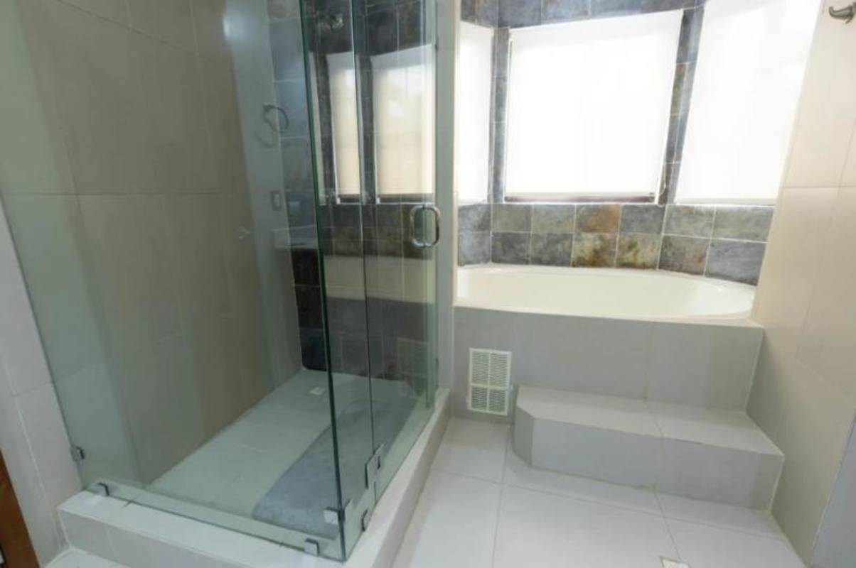 Large open living area with modern lighting fixtures in Costa Sur house Panama