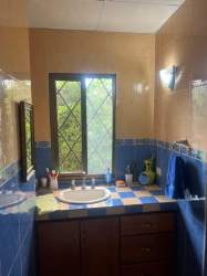Traditional kitchen with wood cabinetry and breakfast bar in Coronado beach house
