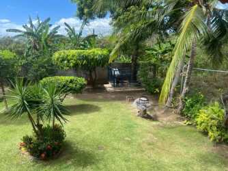 Covered porch with views towards lush tropical garden in Coronado house