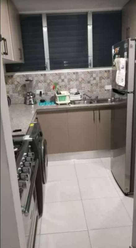 Kitchen with gas oven, washer, cabinets, modern style in PH Lomas de Santa María Panama City