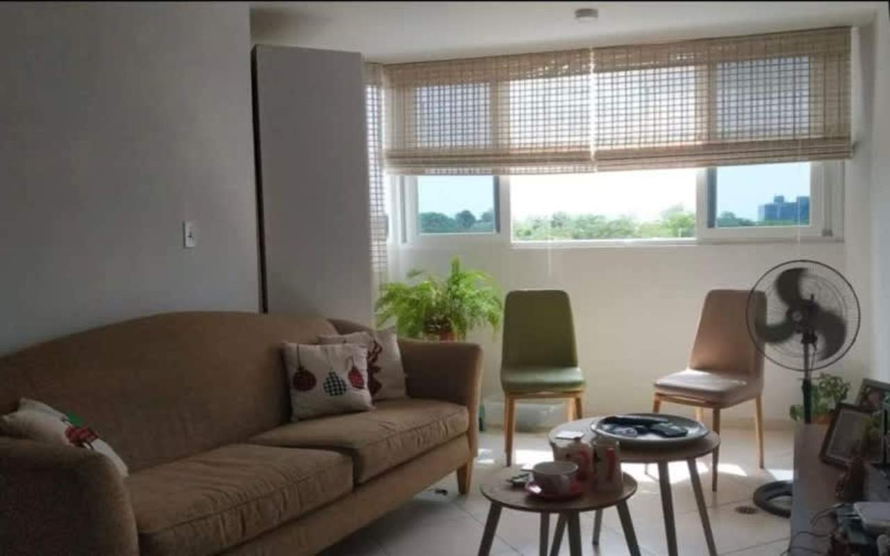 Living room with beige sofa, large windows, bamboo blinds PH Lomas de Santa Maria Panama