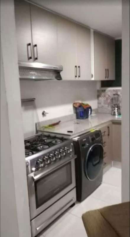 Bright open-plan living and dining area with kitchen, large windows PH Lomas de Santa Maria Panama