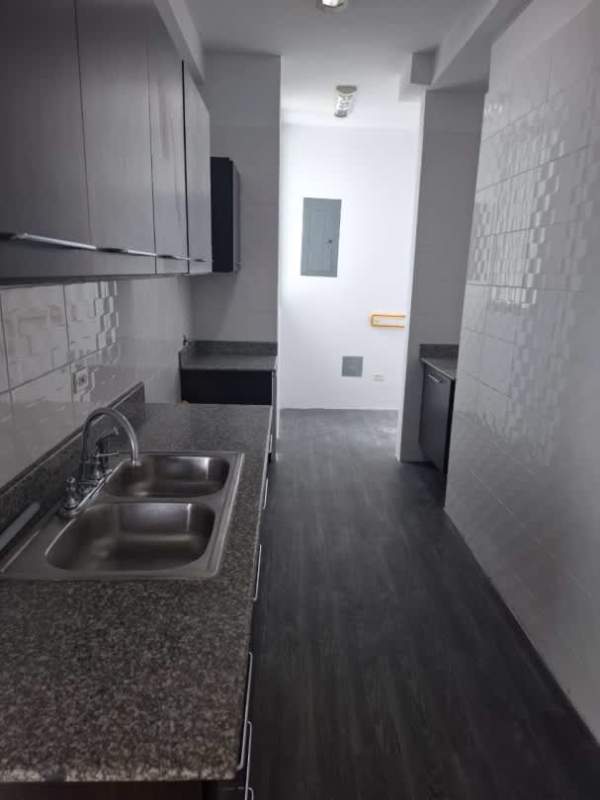 Modern narrow kitchen with granite countertops and tile backsplash in PH Bay Front Bella Vista Panama