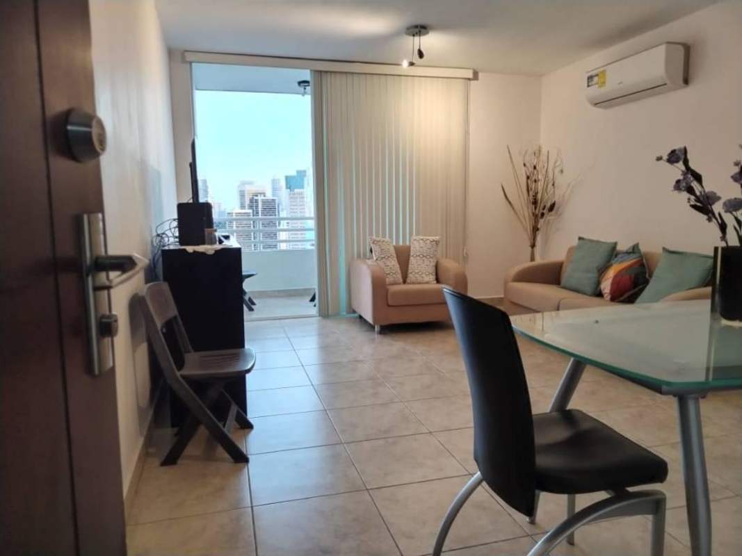 Modern living and dining room with tile floor, AC, glass table and balcony view city Panama City