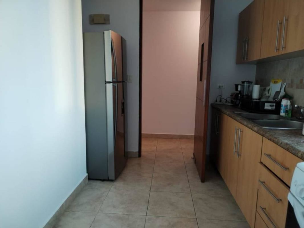 Modern kitchen with wood cabinets, granite countertops, tiled backsplash and appliances PH Vista Tower Panama