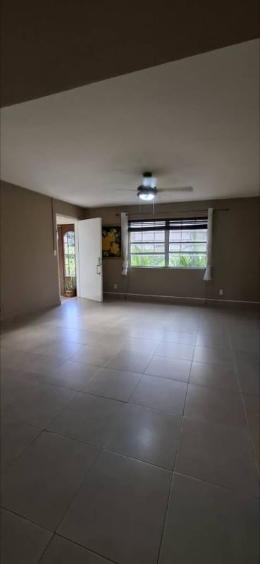 Bedroom with large window, garden views and AC unit in Clayton Park Residences Panama City