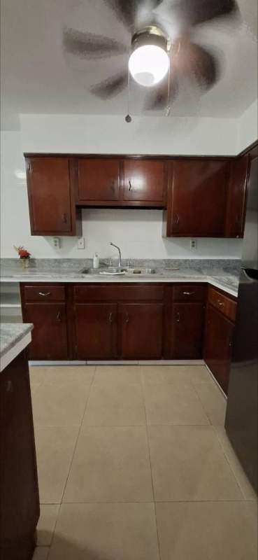 Bright living room with tile floors and sliding doors leading to large terrace at Clayton Park Residences Panama