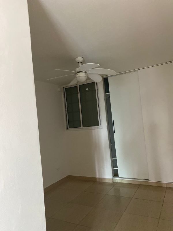 Bedroom with tile flooring, built-in closet, ceiling fan PH Carrasquilla Urban Center Panama City
