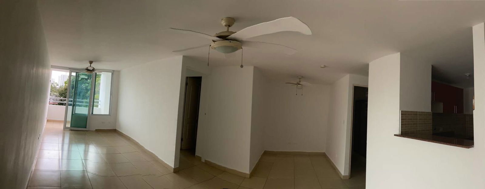 Living dining area with balcony, ceiling fans, view to kitchen PH Carrasquilla Urban Center Panama City