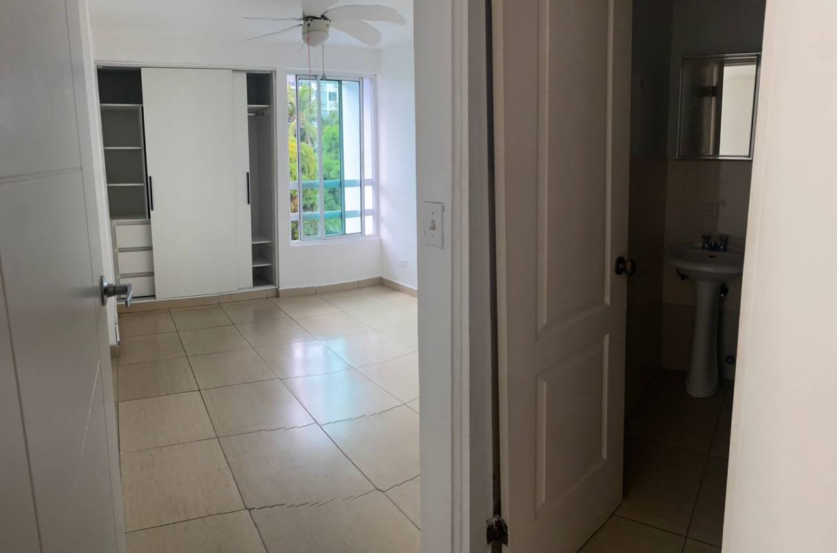 Bedroom with ensuite bathroom, tiled floors, ample window in PH Carrasquilla Urban Center Panama City