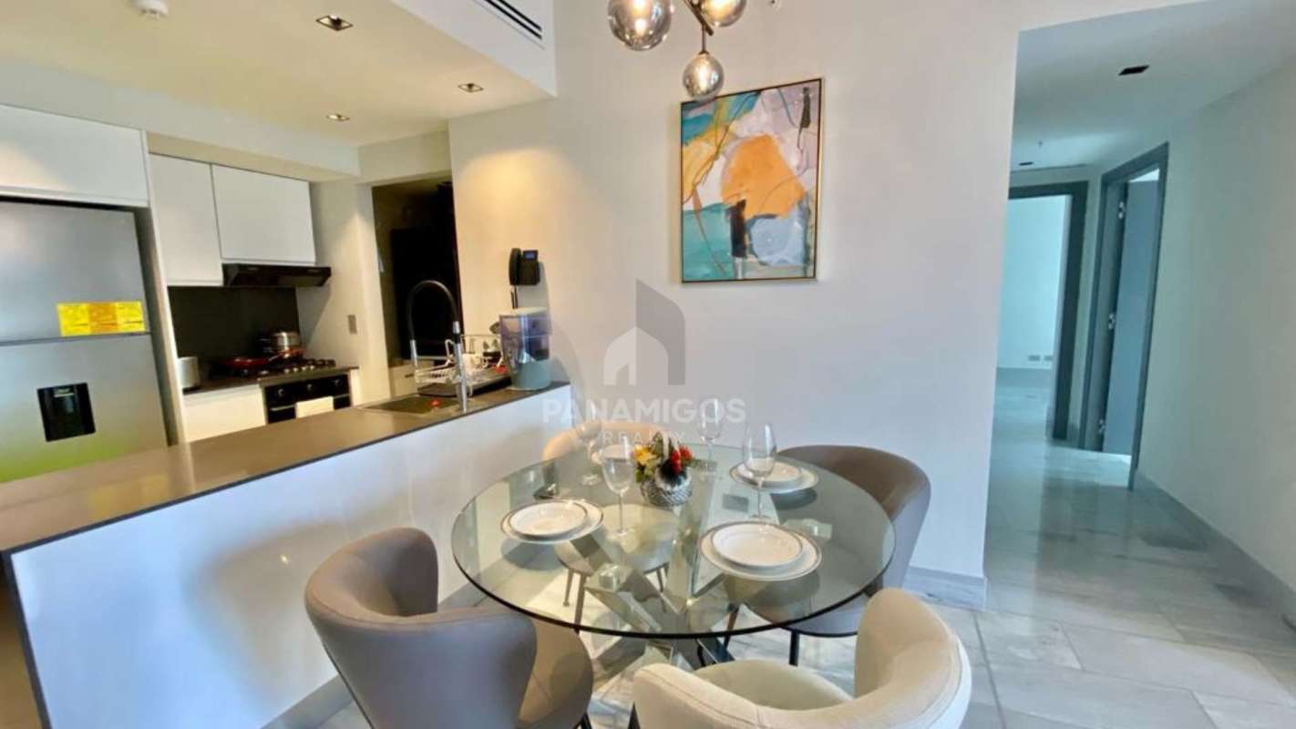 Elegant living area with floor-to-ceiling windows at Nuovo by Armani Casa overlooking city and ocean