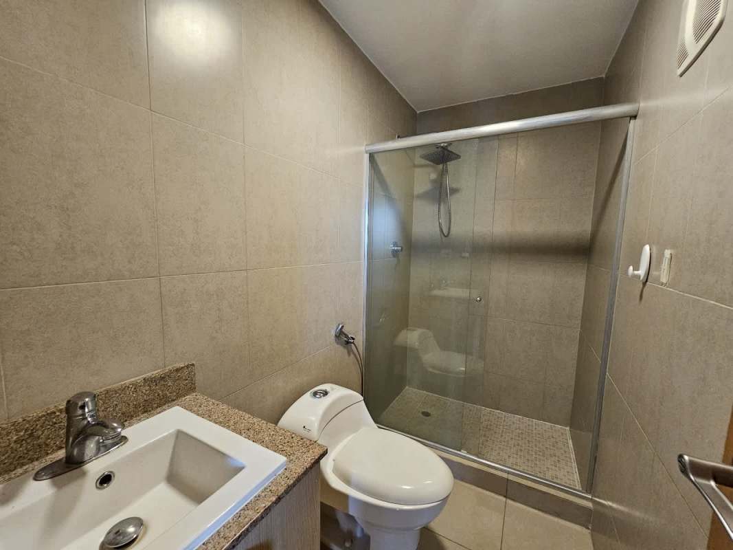 Bathroom with glass shower enclosure granite countertop at PH Rokas Panama
