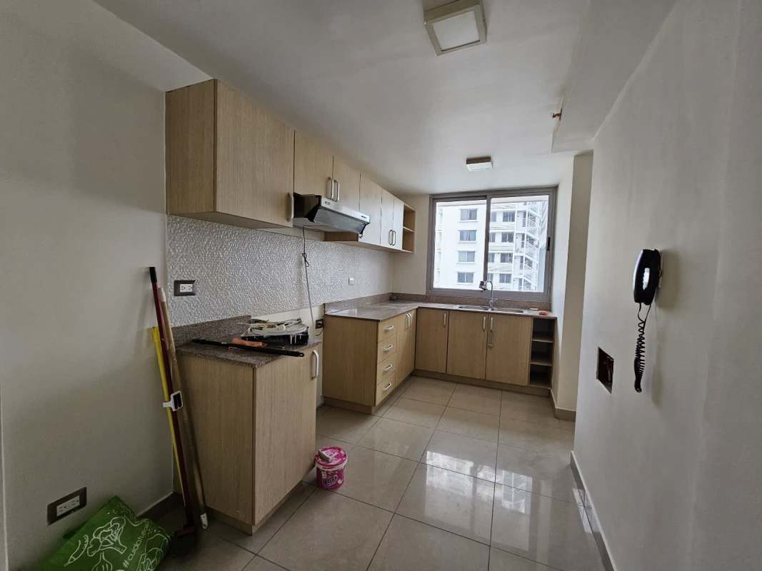 Modern bright kitchen with granite counters and textured backsplash at PH Rokas Condado del Rey