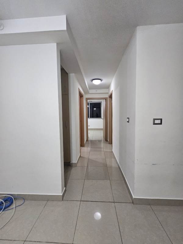Bright corridor in PH Rokas with neutral colors and tiled floors