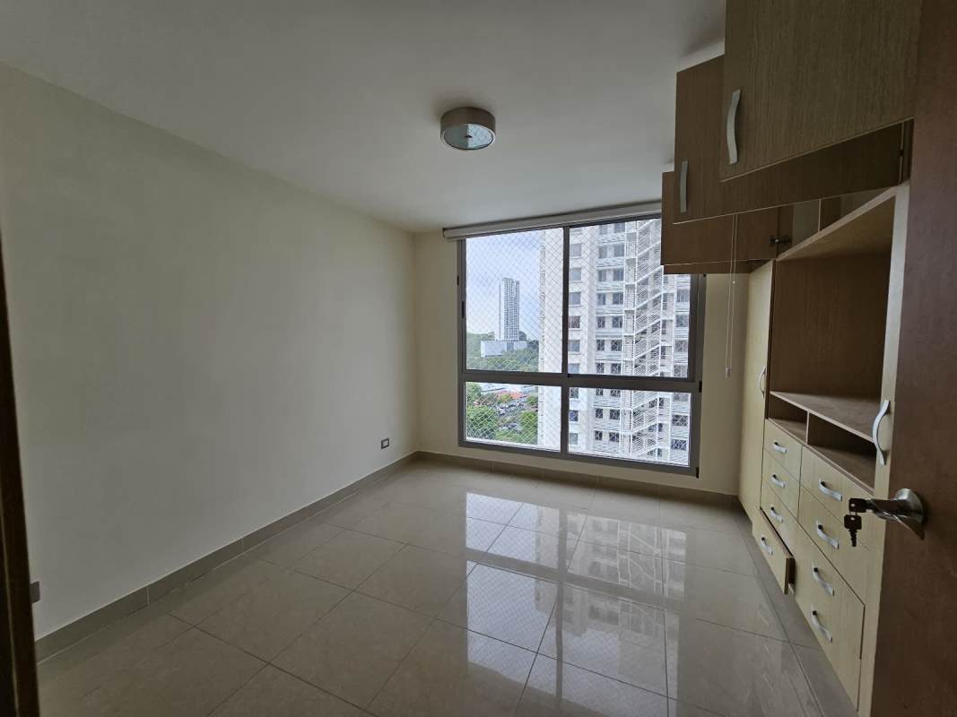 Bedroom features large window built-in cabinetry tiled floors PH Rokas