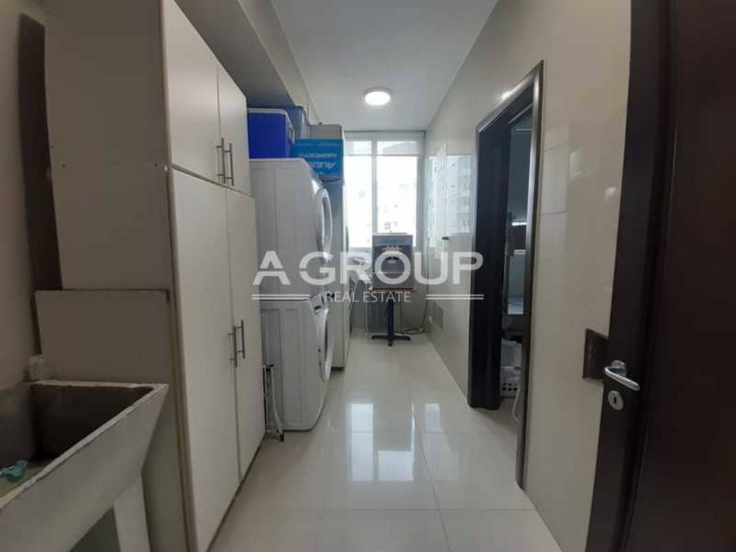 Laundry room with stacked washer & dryer, cabinets, utility sink at PH Aventura Tower Punta Paitilla Panama City