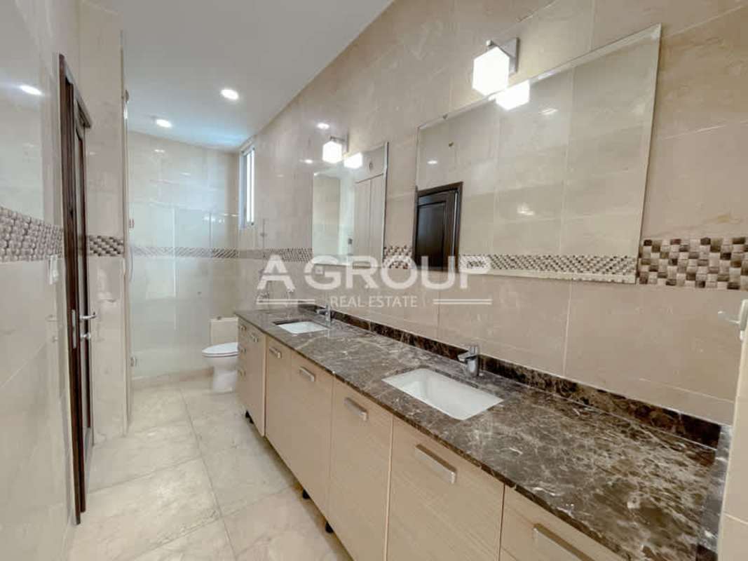 Modern bathroom with double sinks, marble counter, large mirror in luxury apartment Aventura Tower Panama