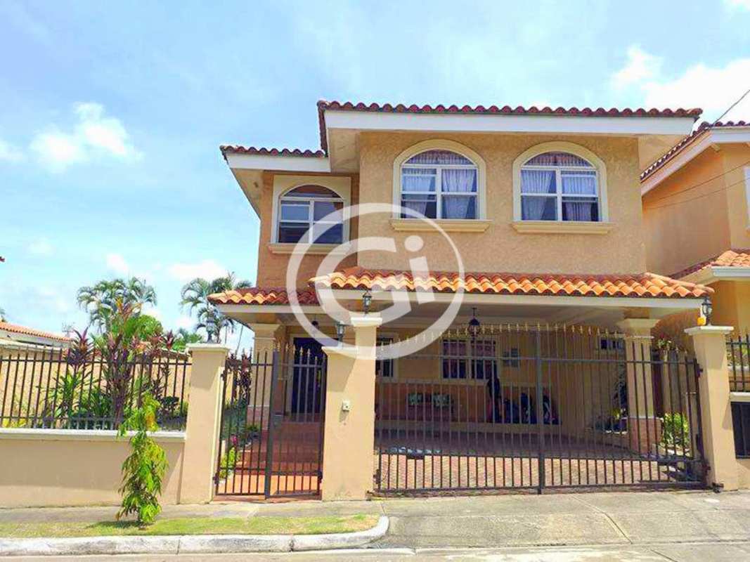 Spacious living room with bulkhead ceiling, chandelier, large windows in house at Residencial El Doral Panama