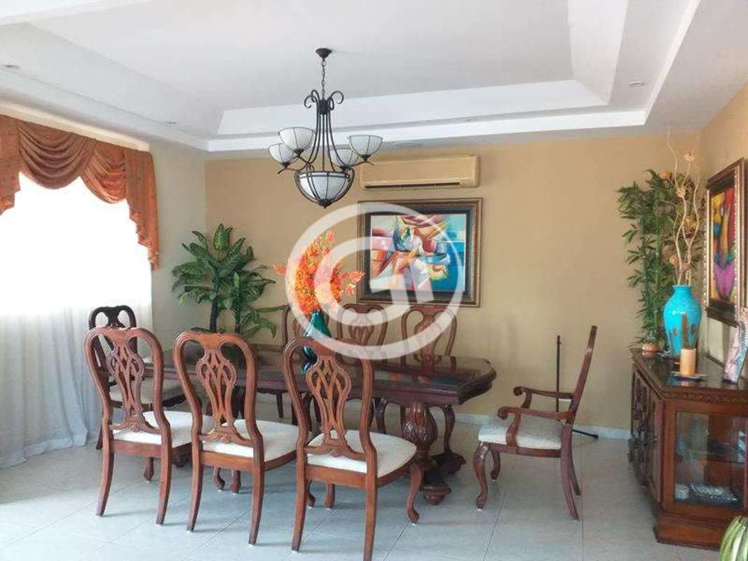 Covered patio with bar counter, grill, seating in house at Residencial El Doral Panama