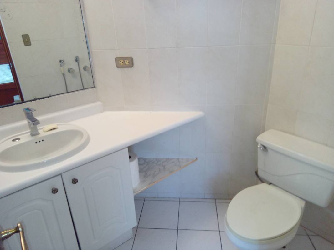Compact bathroom with white sink, cabinet, mirror in Park View II El Dorado Panama