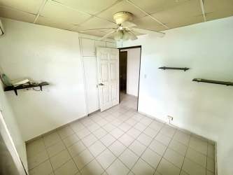 Bedroom with ceiling fan tiled floor built-in closet Monterregio affordable house Panama