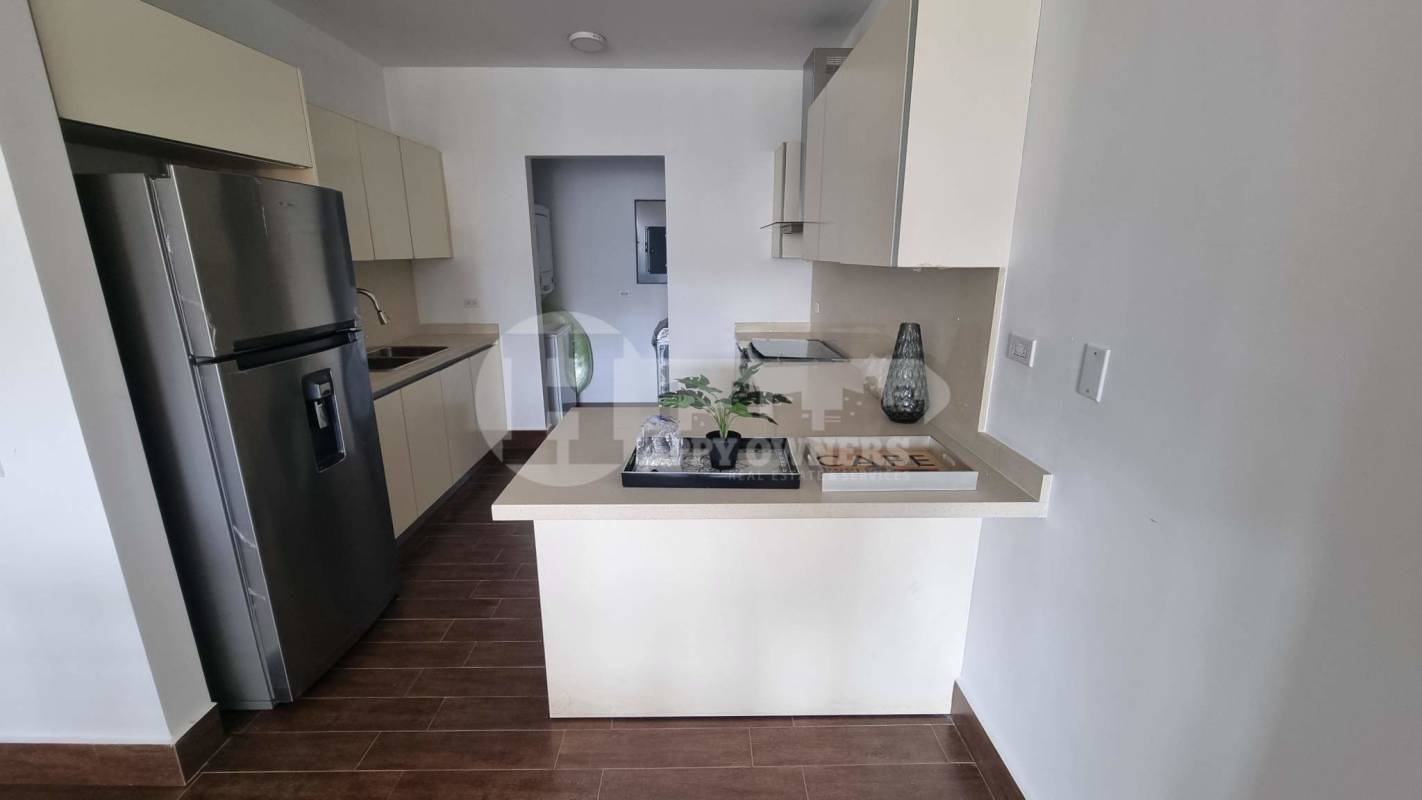 Large outdoor swimming pool surrounded by gardens and sun deck at PH Costamare Panama