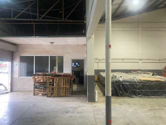 Partitioned office space inside warehouse with industrial lighting in Aguadulce Coclé Panama