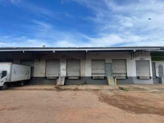 Industrial warehouse street view with delivery truck parked at docks in Aguadulce Coclé Panama
