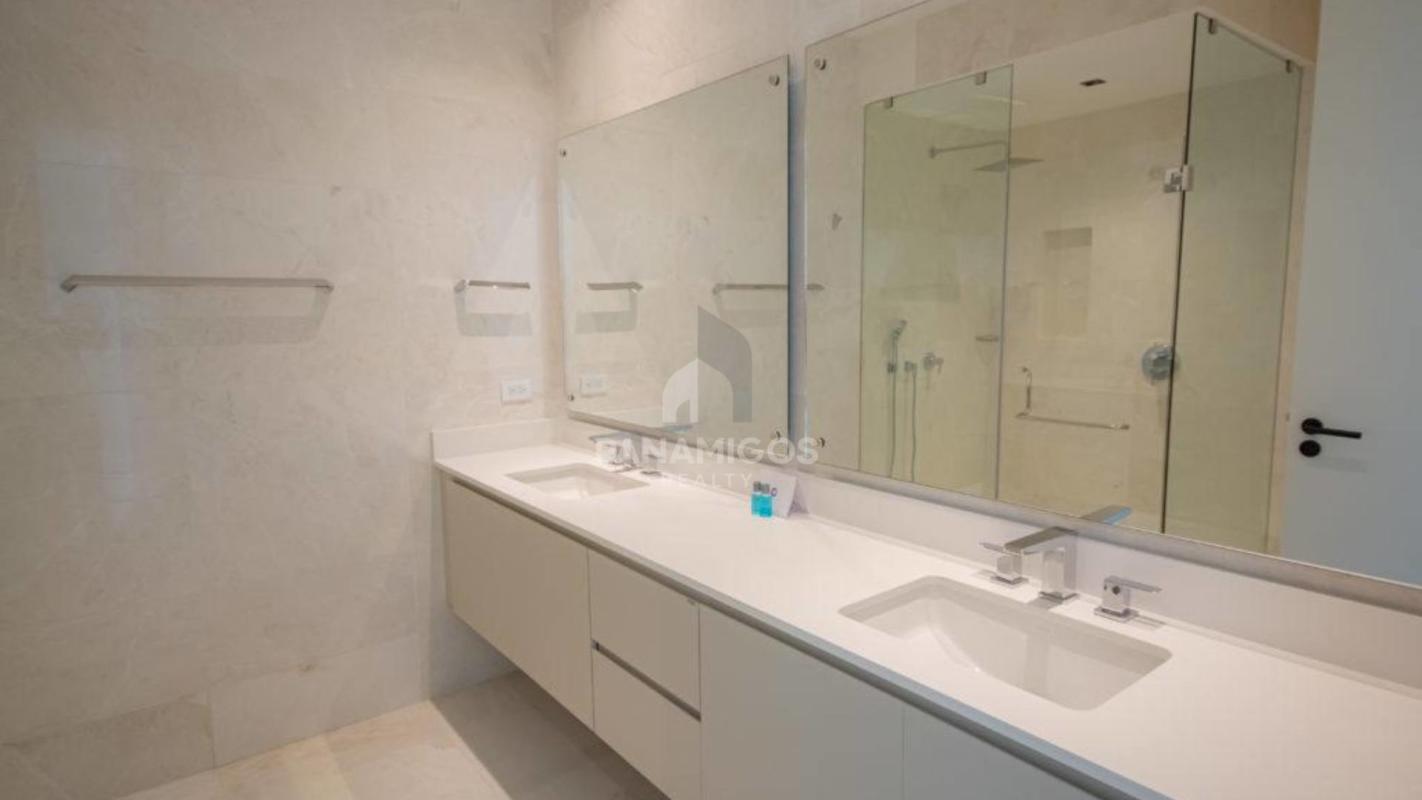 Modern bathroom double sink large mirror glass enclosed shower PH Beach Club Residences Panama
