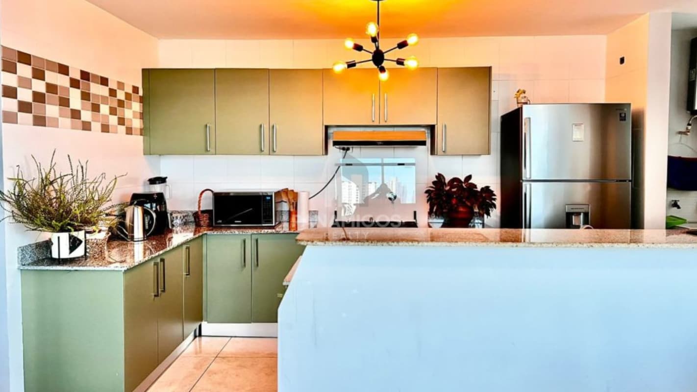 Modern kitchen with granite countertops and breakfast bar in PH Oasis Via Porras Panama City